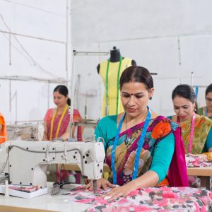 Woman,Textile,Worker,Using,Sewing,Machine,On,Production,Line